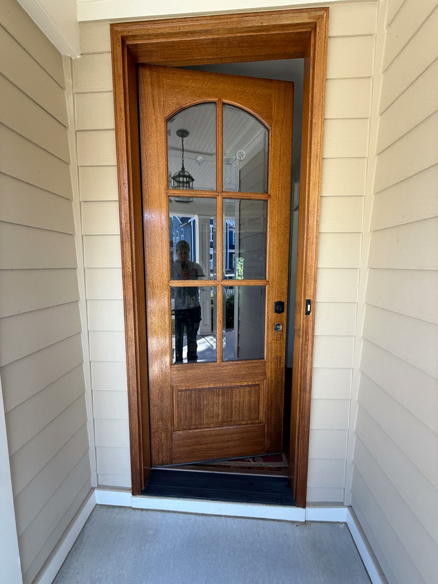 Mahogany front entry door refinished with a warm wood stain