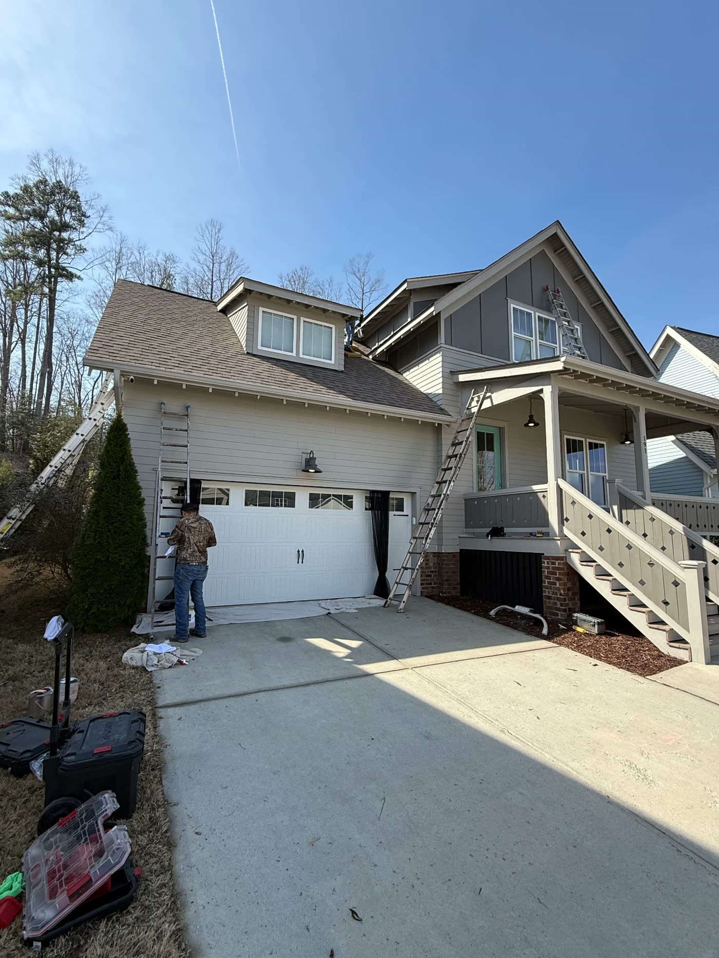 Two-tone craftsman exterior repaint with crew ladders in place