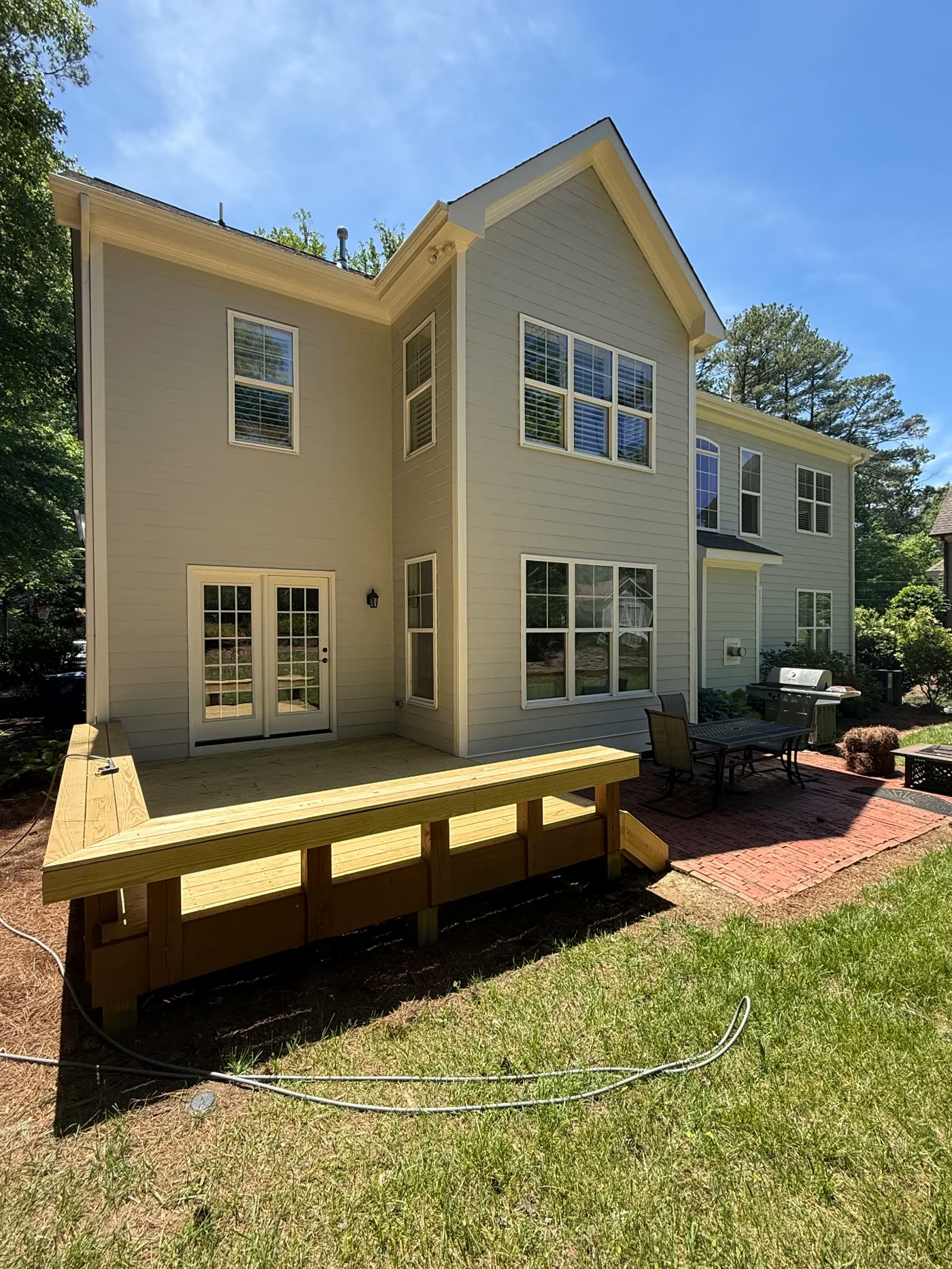 Freshly painted home exterior with new wood deck