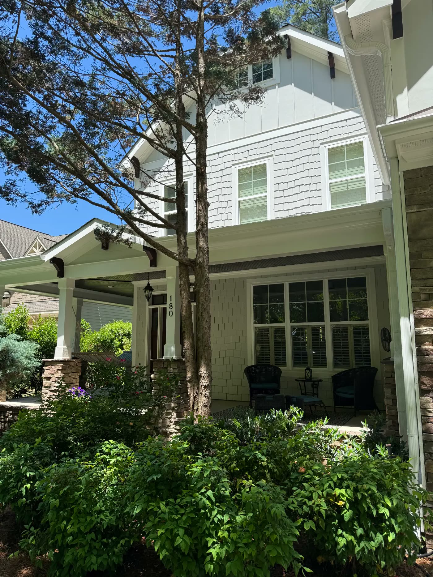 Craftsman home front with freshly painted white and sage siding