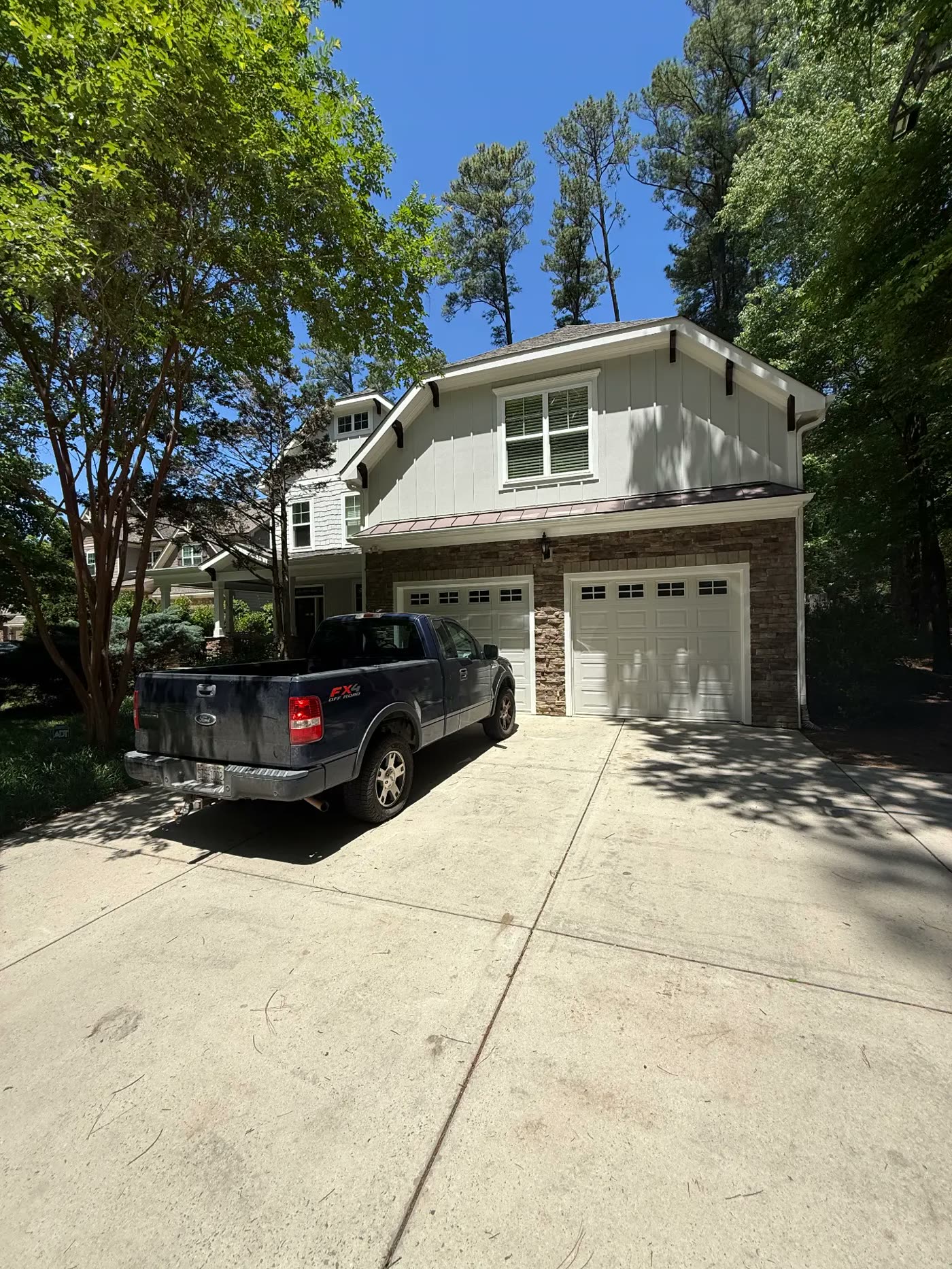 Two-car garage facade with freshly painted board-and-batten siding